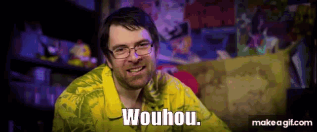 a man with glasses and a yellow shirt is smiling and says wouhou