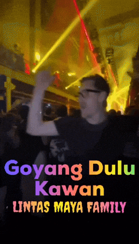 a man is dancing in a club with the words goyang dulu kawan lintas maya family above him