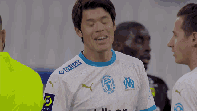 a soccer player wearing a white and blue jersey with the word passions sport on the sleeve