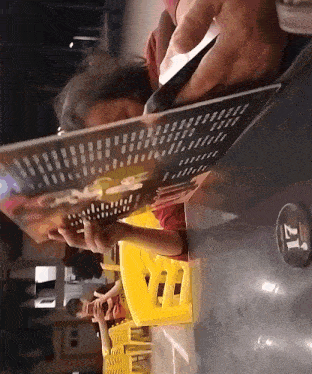 a person sitting at a table looking at a menu that says 21