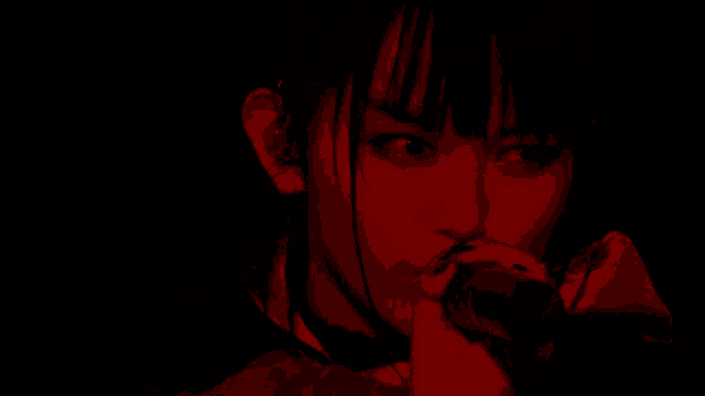 a woman singing into a microphone with a red light shining on her face