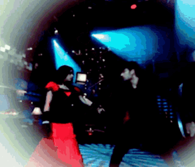a blurry photo of a man and woman dancing in a dark room