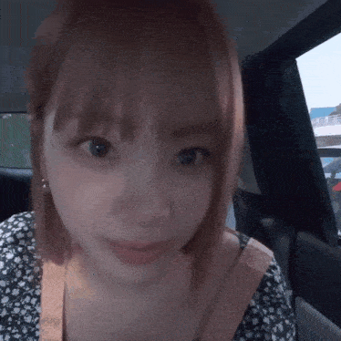 a close up of a woman sitting in a car