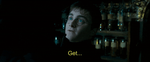a man in a dark room with the word out in yellow letters