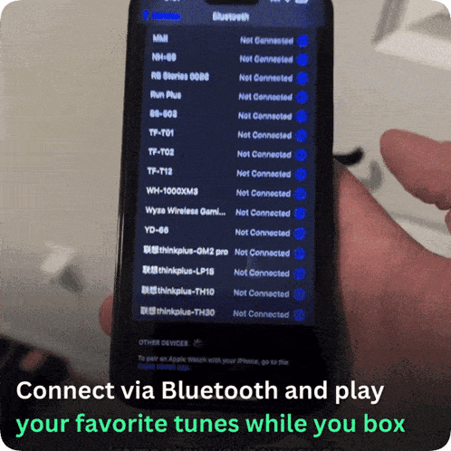 a person holding a phone that says connect via bluetooth and play your favorite tunes while you box on the bottom