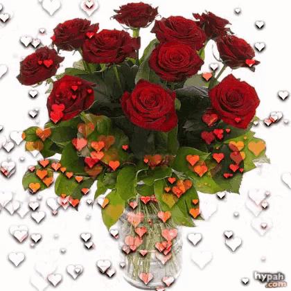 a bouquet of red roses in a glass vase with hearts around it
