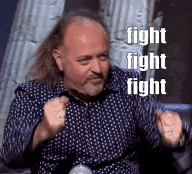 a man with long hair and a beard is giving a thumbs up and the words fight fight fight are above him
