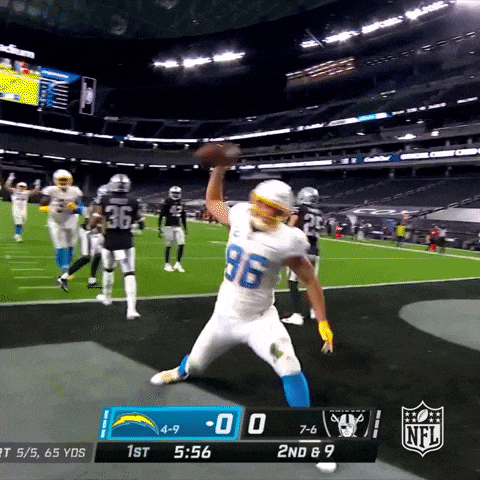 a football player with the number 96 on his jersey jumps in the air