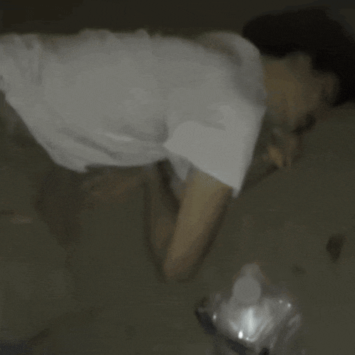 a blurry picture of a man laying on the floor