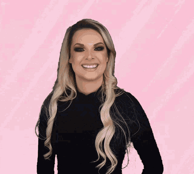 a woman with blonde hair wearing a black shirt with three arrows on it