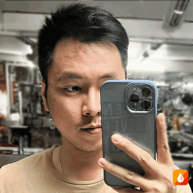a man is taking a picture of himself with a phone that has the word ev on the back