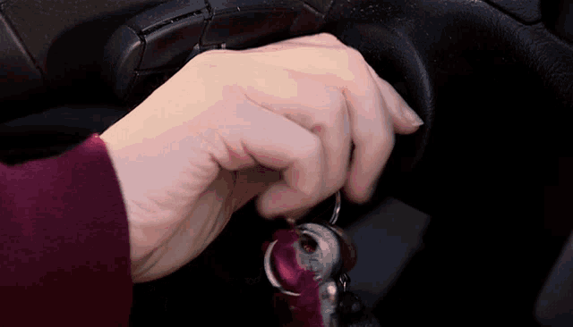 a close up of a person 's hand holding a key that says ' a ' on it