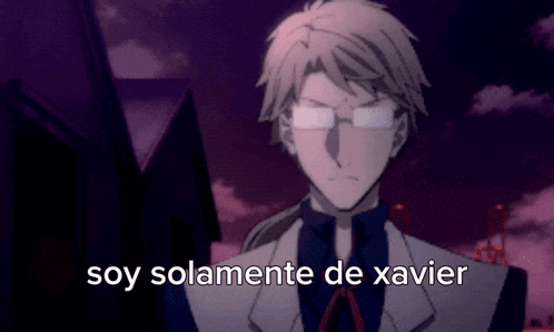 a man with glasses is standing in front of a building with the words `` soy solamente de xavier '' written on it .