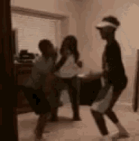 a blurry picture of three people dancing in a living room .
