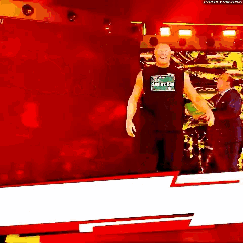 a man is standing on a stage wearing a shirt that says smackdown on it .