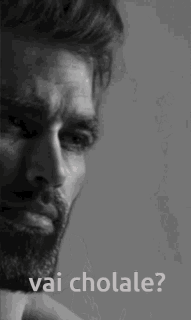 a black and white photo of a man with the words vai chola le on the bottom