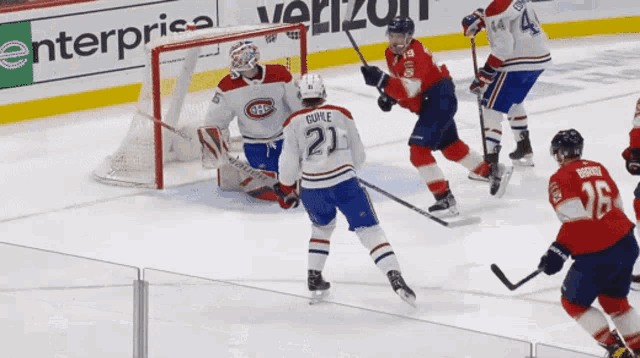 a hockey game is underway with a verizon ad in the background