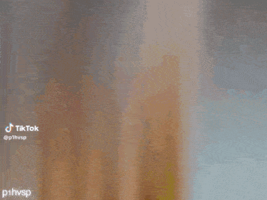 a person is covering their face with their hands in a video .
