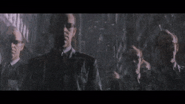 a group of men in suits are standing in the rain .