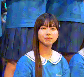 a girl with long hair is wearing a blue shirt with a white collar and a white collar .