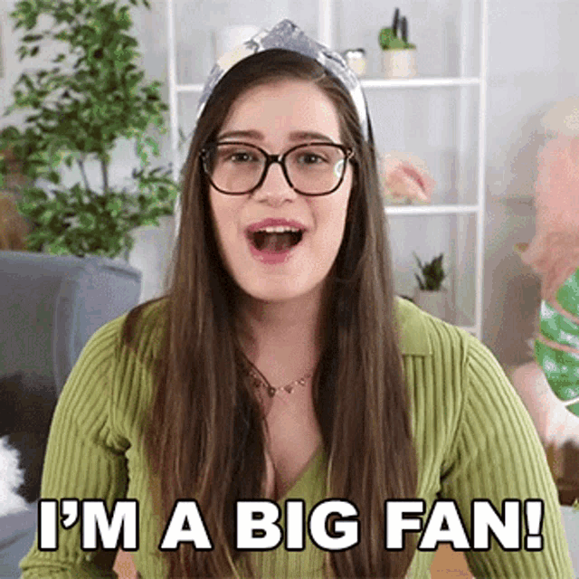 a woman wearing glasses and a headband says i 'm a big fan !