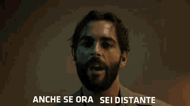 a man with a beard is saying anche se ora sei distante