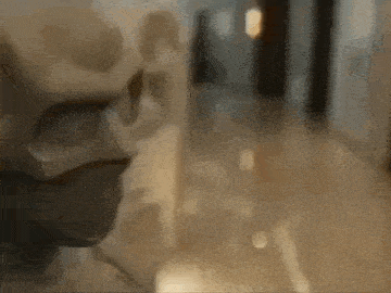 a statue of a person wearing a mask is standing in a hallway .