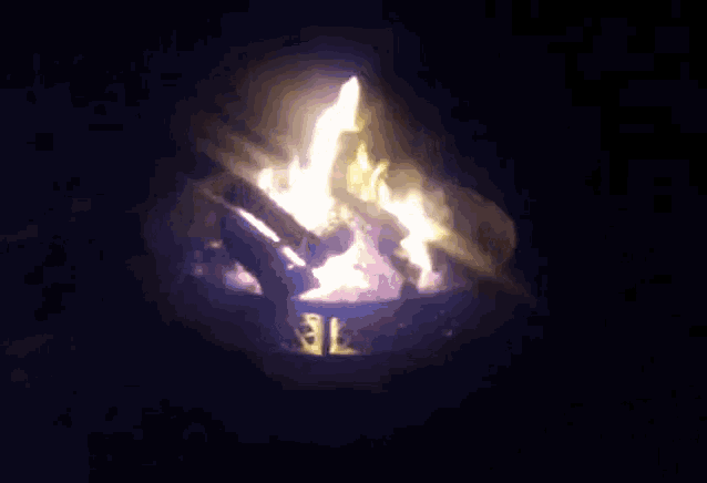a fire is burning in a metal container with the number 12 on the bottom