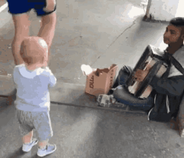 a little boy standing next to a man playing an accordion