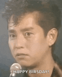 a man is singing into a microphone and saying `` happy birsday ! ''