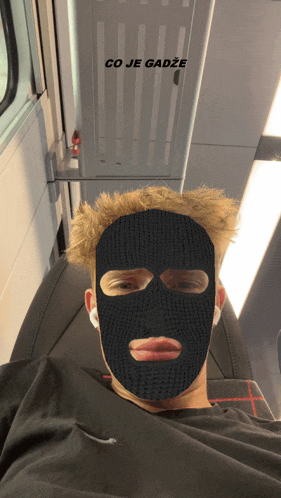 a man wearing a black ski mask with the words co je gadze above him