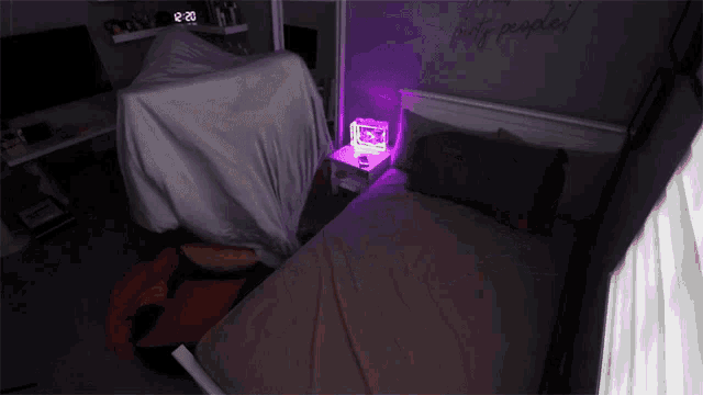 a bedroom with a bed and a clock that says 12:20