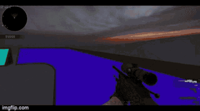 a person holding a sniper rifle in front of a blue screen