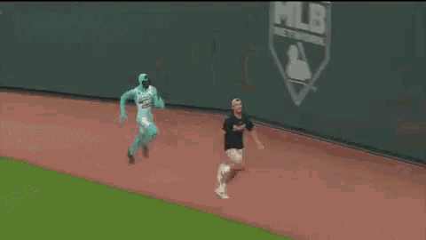 a man in a green costume is walking on a track