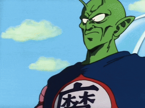 a green cartoon character with chinese characters on his shirt