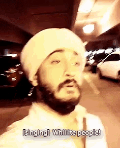 a man with a beard wearing a white hat says singing whiiite people
