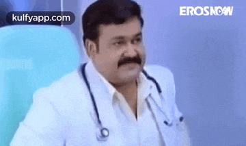 a doctor with a mustache and stethoscope around his neck is sitting in a chair .