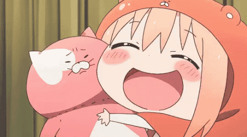 a girl in an orange hat is holding a stuffed animal and smiling