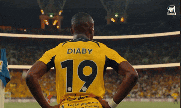 a man wearing a yellow jersey with the number 19 on the back