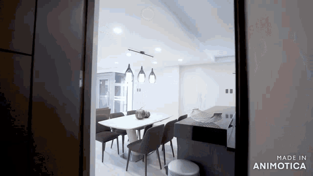 a room with a table and chairs and the words made in animotica