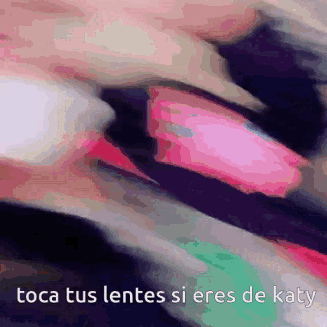 a close up of a person 's face with the words " toca tus lentes si eres de katy "