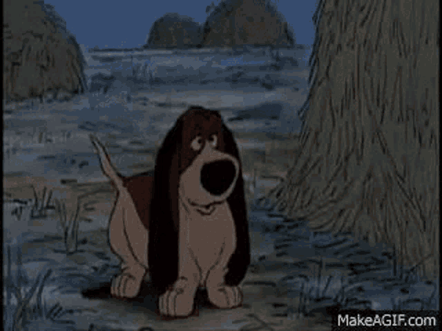 a cartoon dog is standing next to a pile of hay in the grass .