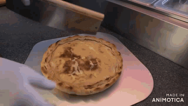 a pizza is being taken out of the oven and made in animatica