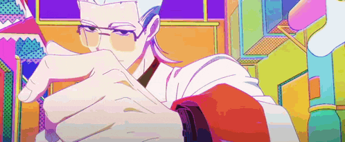 a man with glasses is holding a piece of paper in his hand in a colorful room .