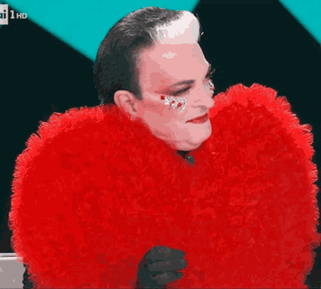 a man in a red fur coat is on a tv screen with the number 1 hd on it