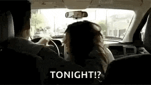 a man and a woman are driving a car and the woman is saying `` tonight ? '' .