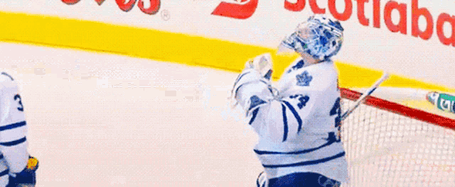 a hockey player in front of a banner that says cd bank