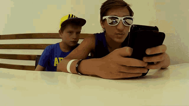 a boy wearing a blue shirt with the letters ap on it
