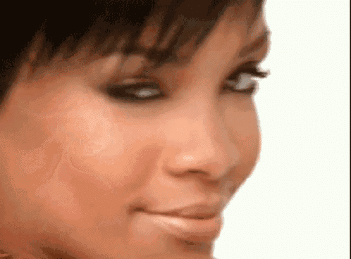 a close up of a woman 's face with a white background