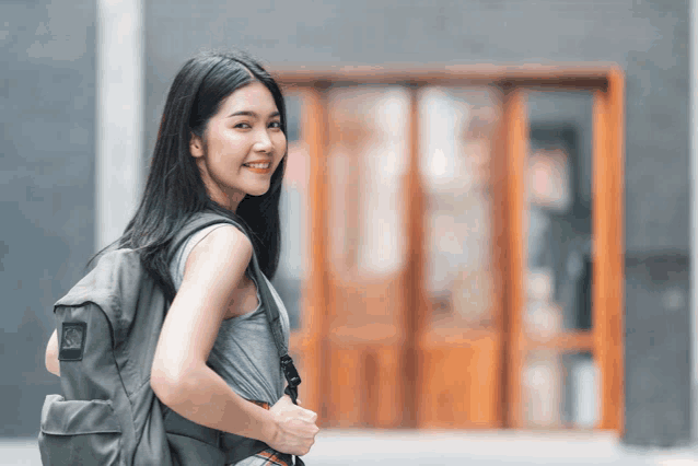 a woman wearing a backpack with the letter s on the back